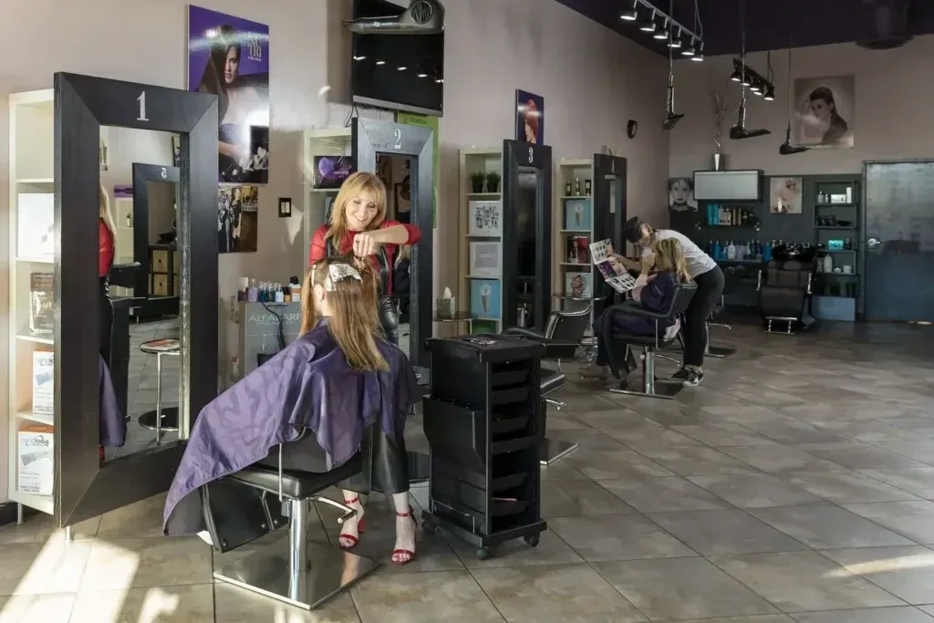 A stylist working with a client inside Raya Hair Co